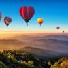 Landschap Wallgroup | Grote Groep Luchtballonnen Boven Een Mistig Berglandschap Fotobehang