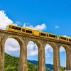 Architectuur Wallgroup | Gele Trein Op Een Viaduct In Frankrijk Fotobehang