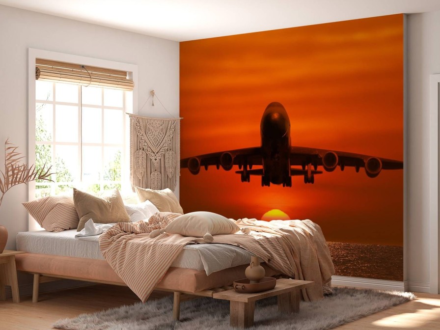 Transport Wallgroup | Passagiersvliegtuig Boven De Zee Bij Zonsondergang Fotobehang