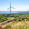 Transport Wallgroup | Rode Trein Langs Windmolens Fotobehang